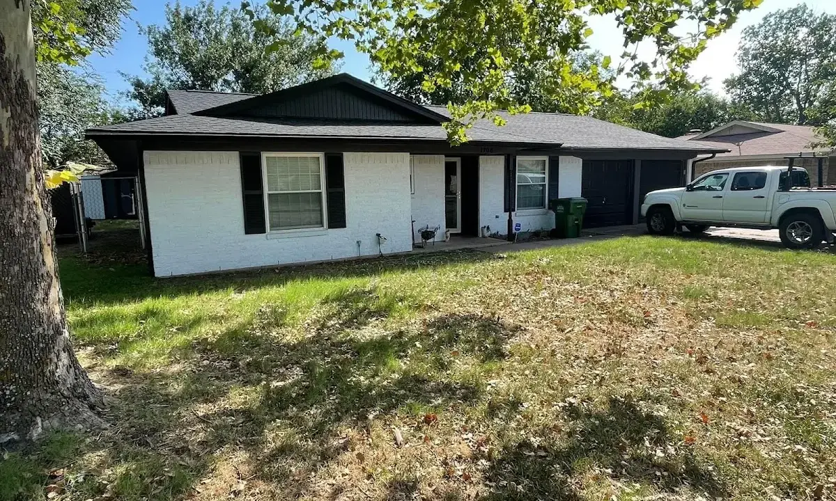 Professional roofing crew working on a residential roof in South Kingstown